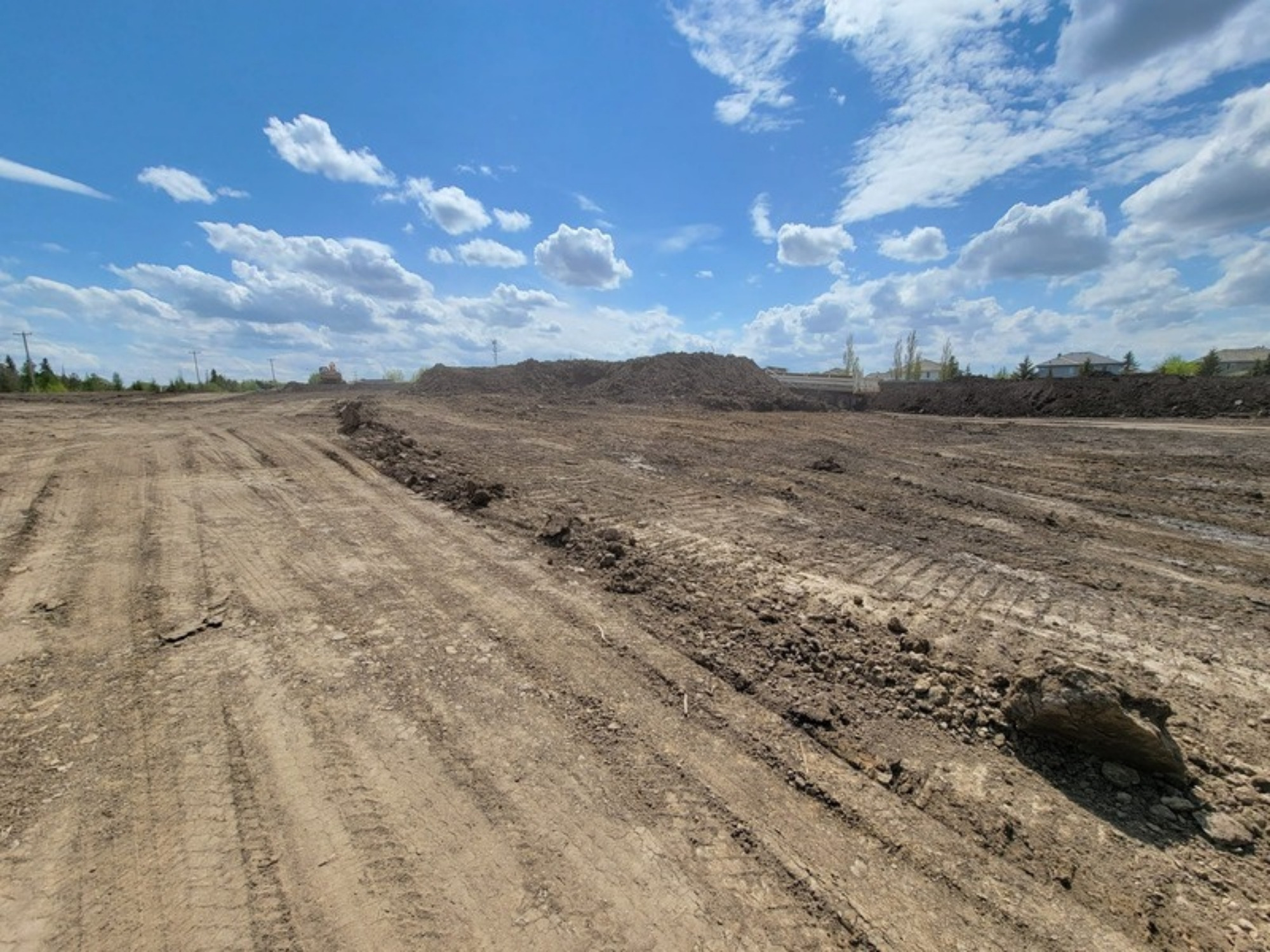 Graded earthworks across an Edmonton-area development