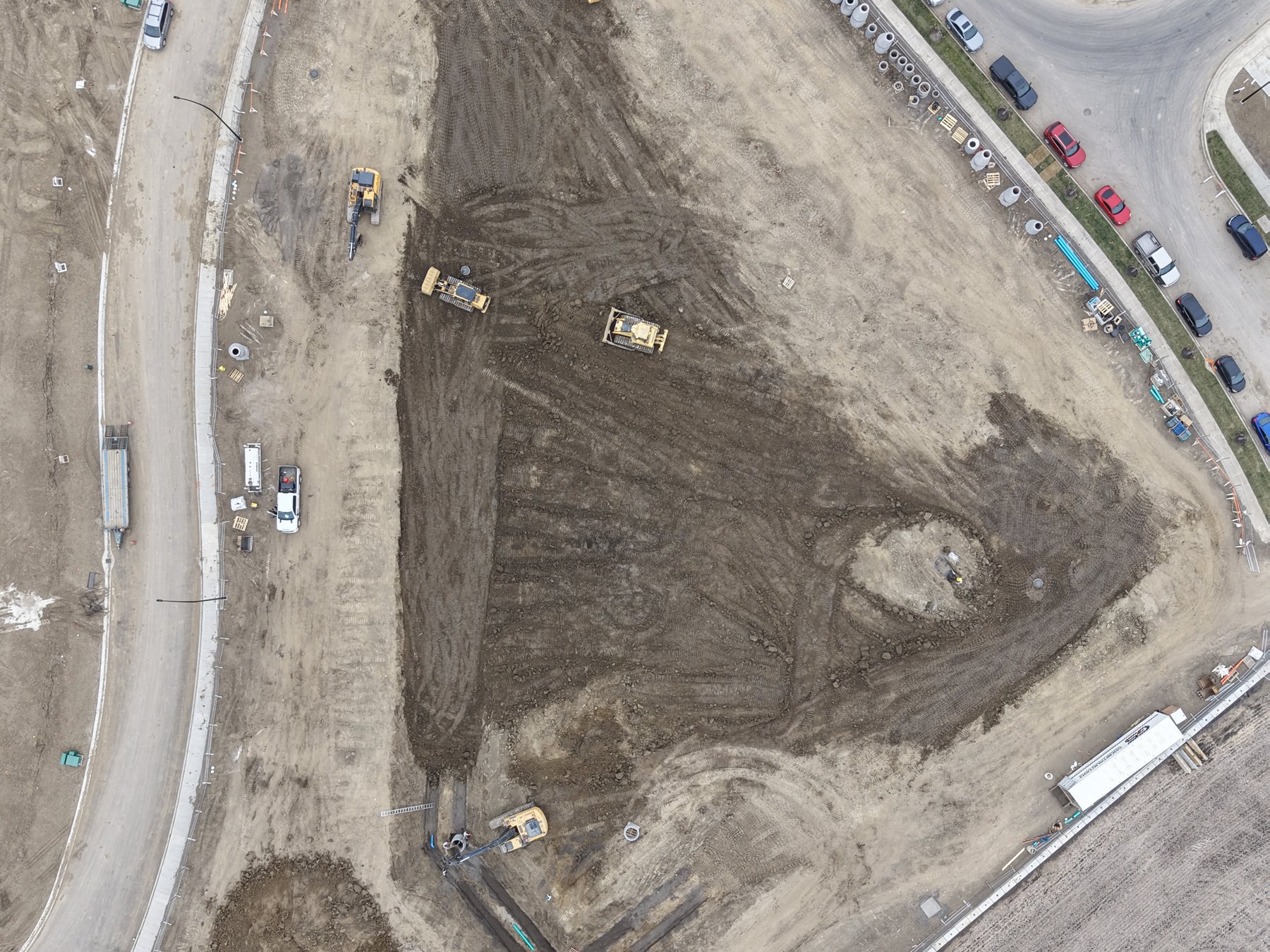 Top-down aerial of a Spruce Grove development parcel being graded, with curbs and road layout in place
