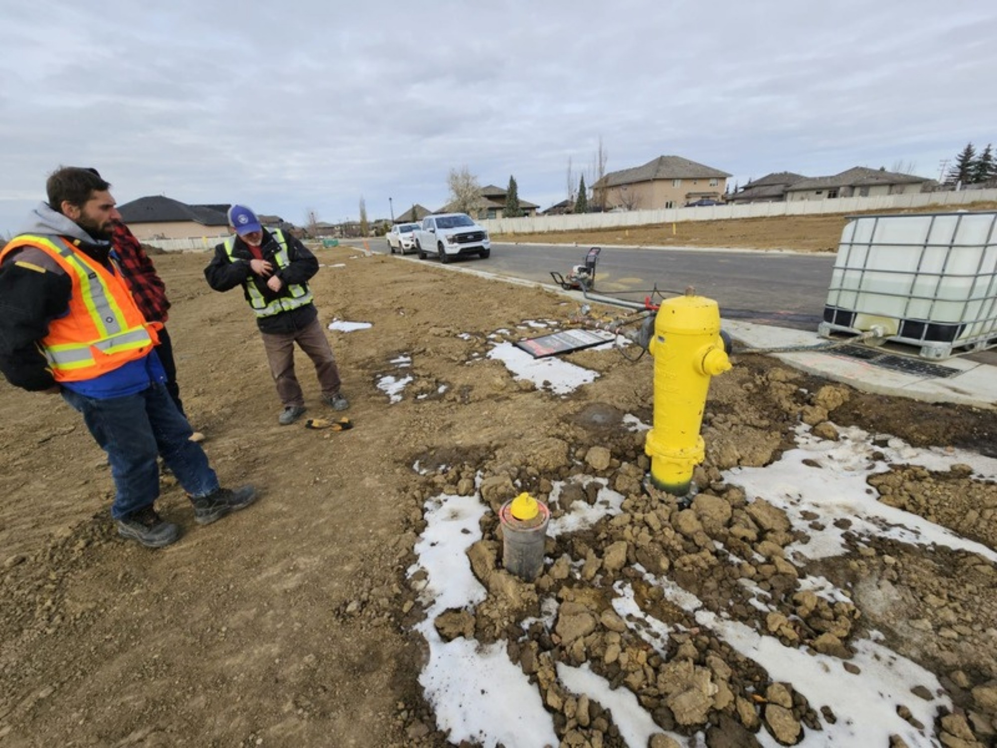 Oasis Engineering crew carrying out hydrant testing beside a water tank truck